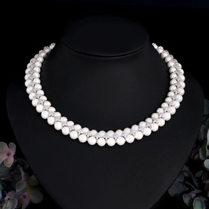 Detail of double-layer freshwater pearl necklace with zircon star spacers on a black bust