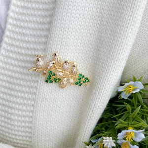 Chinese style bird and flower brooch with sparkling zircon inlays on gold-plated metal