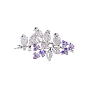 Exquisite silver bird brooch with purple tulip zirconia on a blooming branch