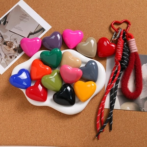 Colorful 3D heart keychain charms with woven ropes and metal carabiners for bags