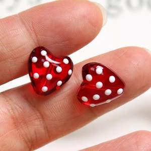 Macro shot of 3D red heart beads with white polka dots for DIY jewelry making