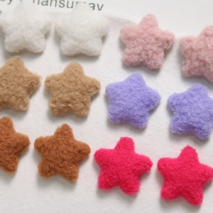 Macro shot of colorful plush star-shaped felt patches for DIY hair accessories and crafts