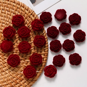 Macro detail of burgundy flocked rose beads with double-sided velvet texture for DIY crafts