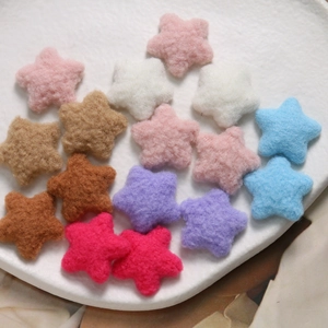 Colorful plush felt star-shaped DIY craft accessories arranged in a ceramic plate