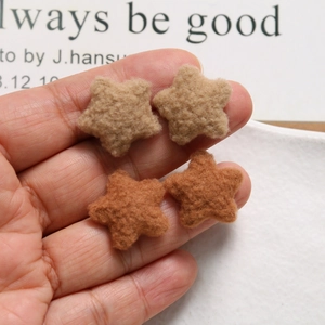 Close-up of plush brown five-point star DIY patches for hair accessories and crafts