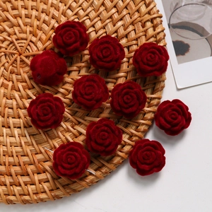 Close-up of ten burgundy flocked velvet rose flower charms for DIY jewelry making