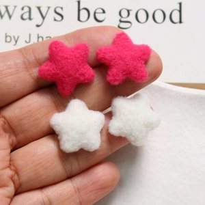 Detailed macro view of plush fuchsia and white wool felt star-shaped DIY accessory charms