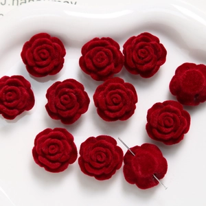 Macro detail of red flocked rose beads with center hole for DIY jewelry making
