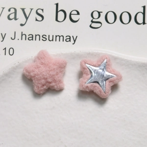 Close-up of pink plush star-shaped DIY accessories and silver mirror finish star elements
