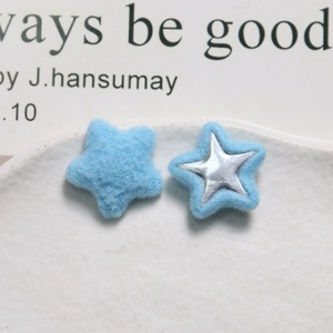 Detail of blue plush star charms with silver metallic center for DIY hair accessories