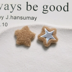 Macro detail of plush brown star-shaped DIY accessories with silver metal center decoration