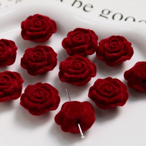 Macro view of vintage burgundy flocked rose beads with holes for DIY jewelry making