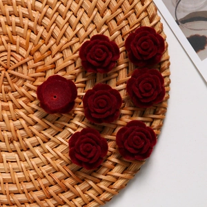 Detailed view of dark red flocked rose charms with back hole for DIY jewelry making