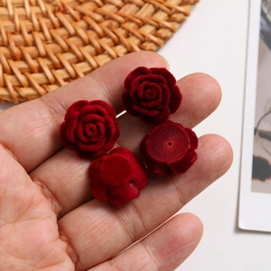 Macro detail of red flocked rose flower charms with hole for DIY jewelry making