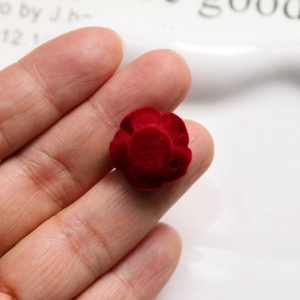 Close-up of deep red flocked velvet rose charm for DIY jewelry and hair accessories