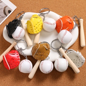 Close-up of mini baseball glove, wooden bat and ball keychain charms in various colors