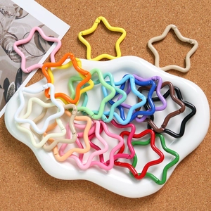 Macro detail of star-shaped alloy spring buckles in colorful macaron lacquer finish
