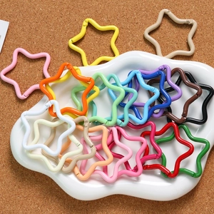 Close-up of colorful star-shaped spring buckles in macaron tones for DIY keychains
