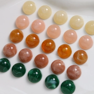 Detail of 12mm resin cabochons with marble texture for DIY jewelry and hair accessories