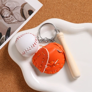 Detailed view of mini baseball keychain with white ball, leather glove and wooden bat