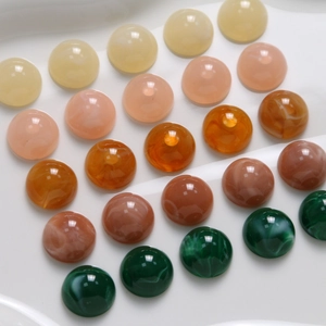 Close-up of 12mm resin round cabochons in various colors for DIY jewelry making