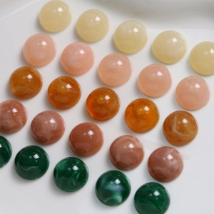 Detail of 12mm resin cabochons with marble texture for DIY jewelry making