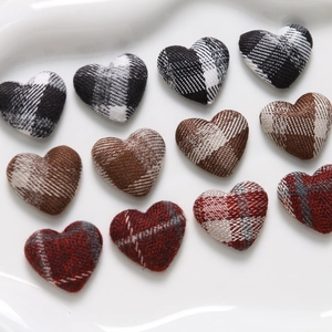 Close-up of heart-shaped plaid fabric buttons in various colors for DIY crafts