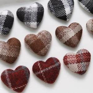 Macro detail of padded plaid fabric heart-shaped DIY craft materials in multiple colors