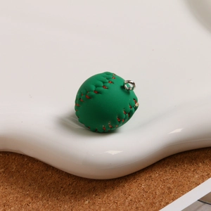 Detail view of green mini baseball keychain with red stitching on white tray