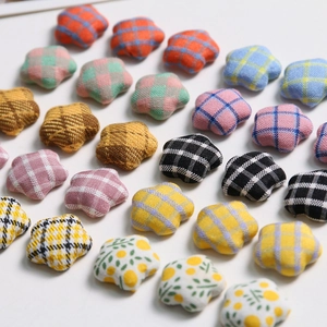 Macro shot of assorted plaid fabric star-shaped buttons for DIY hair accessories