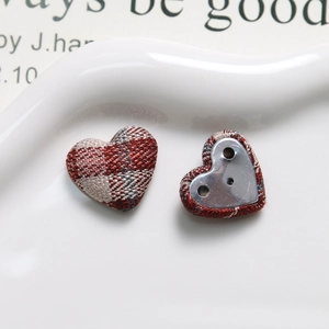 Detail of red and brown plaid heart fabric buttons with metal back for DIY sewing