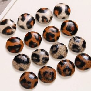 Detailed close-up of leopard print leather buttons and DIY jewelry accessories