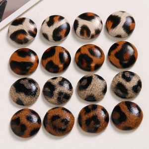 Close-up of leopard print leather fabric buttons for DIY earrings and jewelry accessories