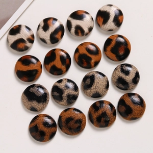 Detail of round leopard print fabric covered buttons for DIY jewelry and hair accessories