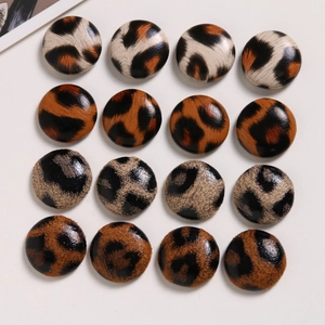 Close-up of 16-piece leopard print fabric buttons for DIY jewelry and hair accessories