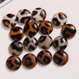 Flat lay macro of leopard print fabric round buttons for DIY craft accessories