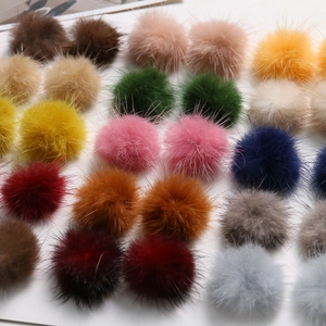 Macro detail of fluffy 3.5cm mink fur balls in assorted colors for DIY handmade jewelry