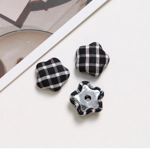 Detail of Gingham fabric button with star shape and metal back for DIY jewelry making
