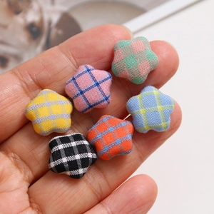 Macro detail of colorful star-shaped checkered fabric buttons for DIY jewelry making