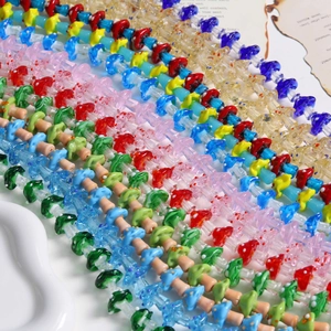 Detailed macro view of assorted colorful glass mushroom beads with white polka dot patterns