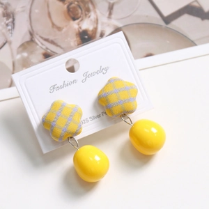 Detail of yellow checkered star fabric and resin bead earrings on display card