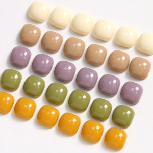Close-up of 10mm glossy square resin cabochons in mixed colors for DIY jewelry crafts