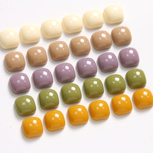 Close-up of 10mm square resin flatbacks in various glossy Morandi colors for DIY jewelry