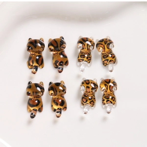 Close-up of DIY resin cat charms with leopard and tiger patterns for jewelry making