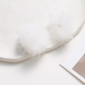 Macro shot of fluffy 3.5cm white mink fur balls for DIY jewelry and hair accessories