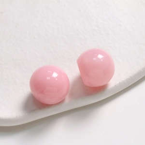 Close-up of 20mm translucent pink resin dome cabochons for DIY jewelry making