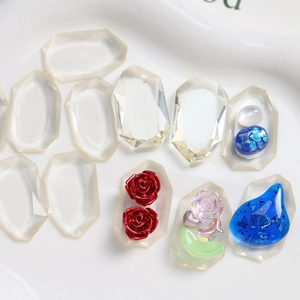 Macro shot of faceted resin charms with crystal bases and colorful floral embellishments