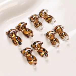 Macro shot of 8 leopard print resin kittens with translucent amber texture and glossy finish