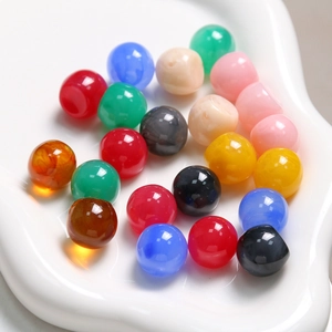 Close-up of colorful ink-wash resin round beads with high polish for DIY jewelry making