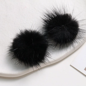 Macro shot of fluffy 3.5cm black mink fur pom poms for DIY jewelry and hair accessories